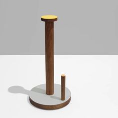 a wooden object on a white surface with a shadow from the top and bottom half