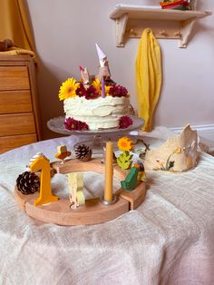 a birthday cake with candles and decorations on a table