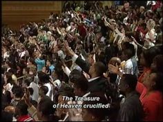 a large group of people standing in front of a crowd with their hands up and the words, the treasure of heaven crucified