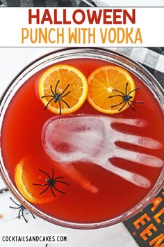 a halloween punch with vodka and oranges in the glass for garnishes