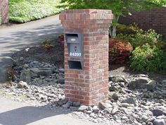 a brick mailbox sitting on the side of a road