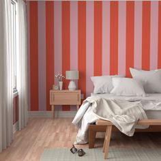 a bedroom with red and white stripes on the wall, bedding and nightstands