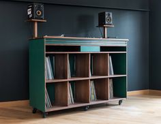 an old record player is sitting on top of a bookcase