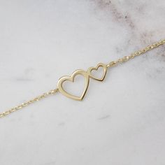 "\"Two hearts close together! What a wonderful feeling, warm and loving. Whether it is a gift or for you, the true meaning is always the same. Looking at the world through love makes everything more beautiful!\" --Fairy Goldcharm You may even combine it with our heart rings for a more loving look! https://www.etsy.com/listing/497167470/gold-heart-ring-gold-ring-rose-gold-14?ref=shop_home_active_46 https://www.etsy.com/listing/487581520/heart-ring-gold-heart-ring-yellow-gold?ref=shop_home_active_ Delicate Yellow Gold Heart Bracelet For Anniversary, Delicate Yellow Gold Heart Bracelet For Valentine's Day, Elegant Heart Shaped Bracelets For Anniversary, Yellow Gold Delicate Heart Bracelet For Valentine's Day, Delicate Gold Heart Bracelet For Anniversary, Dainty Yellow Gold Heart Bracelet For Mother's Day, Valentine's Day Double Heart Bracelets, Double Heart Yellow Gold Bracelet For Anniversary, Yellow Gold Heart Bracelet For Anniversary On Mother's Day