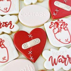 decorated cookies are arranged in the shape of heart and nurse's medical instruments, with words on them