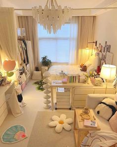 a living room filled with furniture and a chandelier hanging over the top of it