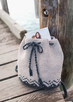 a small bag sitting on top of a wooden dock