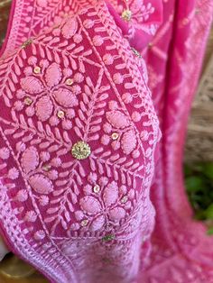 a close up of a pink dress on a mannequin