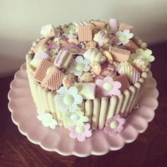 there is a large cake decorated with flowers and marshmallows on the top