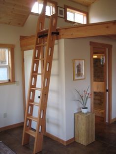 there is a ladder in the corner of this room that leads up to the loft