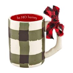 a coffee mug with a red and black bow on the handle that says ho ho honey