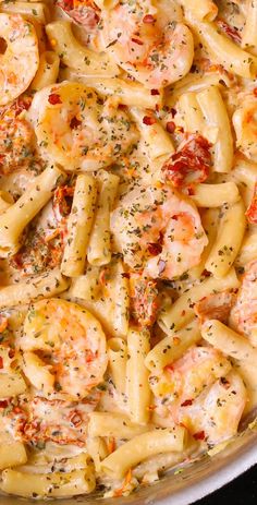 a pasta dish with shrimp and sauce in a pan