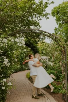 a man and woman are dancing in the garden