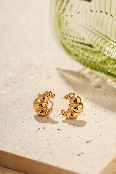 The Croissant Stud Earrings are a nod to effortless Parisian elegance, capturing the charm of a morning stroll through cobblestone streets, coffee in hand. Crafted in 18k Gold Vermeil over Sterling Silver, these delicate earrings evoke the warmth and allure of golden, flaky croissants—perfect for adding a subtle touch of indulgence to your everyday style. Charm Size: 15mm x 12mm, striking the perfect balance between bold and understated. Hypoallergenic: Designed for comfort and sensitivity. Care Flaky Croissants, Croissant Earrings, Parisian Elegance, Coffee In Hand, Cobblestone Streets, Pearl Collection, Delicate Earrings, French Design, Everyday Style