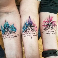 two people with matching tattoos on their arms, both have words written in different colors