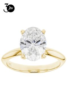 a yellow gold engagement ring with an oval cut diamond in the center and two clawed shoulders