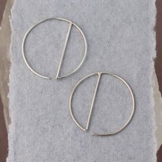 • Sterling Silver Geometric Hoop Earrings -- silver circles with a vertical dividing line, super minimalist and easy to wear• READY TO SHIP • Just over one inch long and wide Modern Metal Round Cartilage Earrings, Modern Round Metal Cartilage Earrings, Minimalist Sterling Silver Round Threader Earrings, Minimalist Metal Cartilage Earrings For Everyday, Minimalist Everyday Metal Cartilage Earrings, Everyday Minimalist Metal Cartilage Earrings, Minimalist Metal Pierced Wrap Earrings, Modern Round Cartilage Earrings With Ear Wire, Minimalist Metal Hoop Earrings