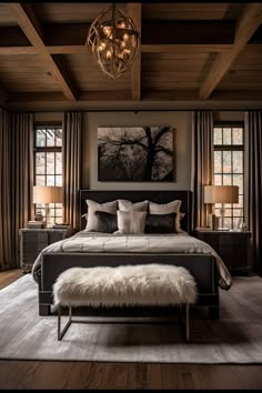 a large bed sitting in a bedroom on top of a wooden floor next to two windows