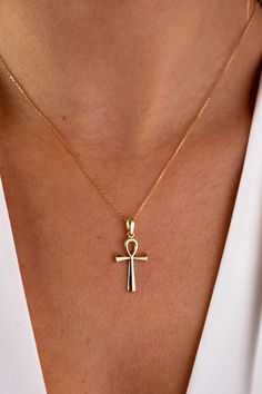 "This 14K gold cross necklace is a beautiful and meaningful piece of jewelry that would make a perfect gift for any occasion. The crucifix pendant is a symbol of faith and devotion, and would be a thoughtful present for a loved one on Christmas, Father's Day, Mother's Day, Valentine's Day, an anniversary, or a birthday. The necklace features a small and dainty cross charm that hangs from a delicate chain, making it perfect for those who prefer a more subtle and discreet look. It would be a suita 14k Gold Cross Necklace For Spiritual Wear, Spiritual 14k Gold Cross Jewelry, Spiritual Cross Necklace In Yellow Gold, Spiritual Yellow Gold Cross Necklaces, Spiritual 14k Gold Crucifix Necklace, 14k Gold Spiritual Cross Necklace, Symbolic Crucifix Cross Necklace As Gift, Symbolic Yellow Gold Cross Necklace, Symbolic Yellow Gold Cross Jewelry