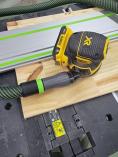 a corded sanding machine on top of a piece of wood