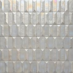 a close up view of a white tile wall