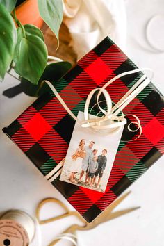 a gift wrapped in red and black plaid paper