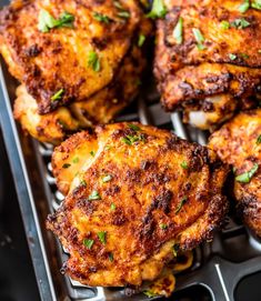 chicken wings with parsley on top in a baking pan