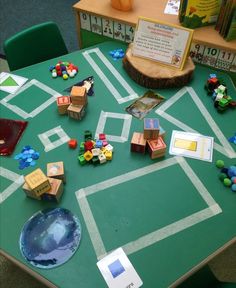 a green table topped with lots of toys