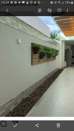 an image of a hallway with plants on the wall