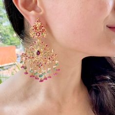 Featuring a pair of earrings inspired from the Edwardian era of jewellery and fused with the traditional Indian jadau craft. It has been handcrafted in 22k gold and embellished with precious rubies, emeralds and pearls. The earrings weigh 37.02 GMs including 5.71 GMs of hanging beads. These timeless earrings bring together classic design and modern beauty, making a sophisticated statement with every wear. Temple Bridal Earrings In 22k Gold With Cutdana, 22k Gold Cutdana Bridal Earrings In Temple Jewelry Style, 22k Gold Bridal Earrings With Cutdana In Temple Style, Fusion Style Yellow Gold Earrings With Tilla, Festive 22k Gold Temple Jewelry Chandelier Earrings, Festive 22k Gold Temple Chandelier Earrings, Yellow Gold Chandbali Chandelier Earrings Temple Style, Yellow Gold Chandbali Chandelier Earrings, Yellow Gold Chandbali Chandelier Earrings In Temple Jewelry Style