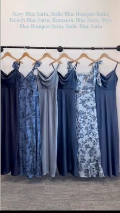 four dresses hanging on a rack in front of a sign that says navy blue, indigo blue, and bronze