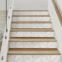 a set of stairs with wooden treads and white tiled walls