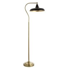 an antique brass floor lamp with a black shade on the top and a white background