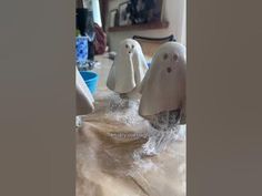 three ghost figurines sitting on top of a table