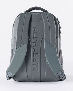 the back side of a gray backpack on a white background