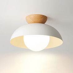 a white ceiling light with a wooden bowl on top