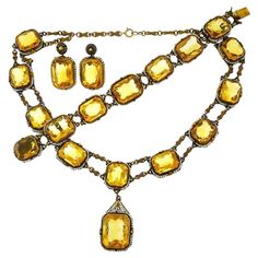 Beautiful Victorian set made of 14 karat (stamped) yellow gold, featuring nineteen emerald mixed cut citrines (approximately 200 carats total) accented with seed pearls. Measurements: necklace 15" x 5/8" (37.5 x 1.6 cm), pendant 1 3/8" x 3/4" (3.3 x 2 cm); bracelet 7" x 3/4" (17.5 x 1.6 cm); earrings 1 1/8" x 3/4" (3 x 1.6 cm). Weight: necklace 57.7 grams, bracelet 32.6 grams, earrings 12.4 grams. Stamped with hallmarks for 14 karat gold. Feminine, exquisite and timeless, the set is a great addition to your jewelry collection. Formal Jeweled Yellow Gold Jewelry, Formal Yellow Gold Jeweled Jewelry, Gold Gemstone Jewelry For Evening, Formal Yellow Faceted Jewelry, Formal Faceted Yellow Gold Jewelry, Formal Yellow Gold Faceted Jewelry, Antique Yellow Gold Jeweled Jewelry, Victorian Gold Faceted Jewelry, Antique Jeweled Yellow Gold Jewelry