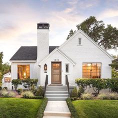 a white house with steps leading to the front door