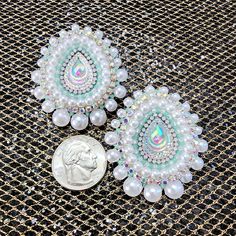 Handbeaded small round earrings made with size 11/0 seed beads, rhinestone Banding and detailed edging. Earrings are backed with white pleather and stud posts. These are the perfect size for everyday wear! Bohemian White Jewelry With Rhinestones, Dangle Beaded Earrings With Rhinestones As Gift, White Rhinestone Teardrop Crystal Earrings, White Crystal Rhinestone Teardrop Earrings, Bohemian Embellished Earrings For Gift, White Teardrop Crystal Earrings With Rhinestones, Embellished White Jewelry For Festive Occasions, Festive White Embellished Jewelry, Bohemian Jeweled Beaded Earrings For Gifts