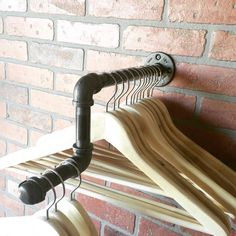 a coat rack made out of wooden clothes hangers