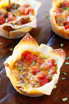 small cups filled with food sitting on top of a wooden table