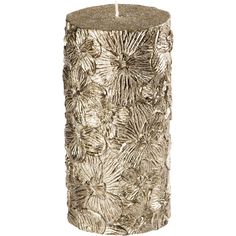 a candle that has been decorated with flowers and leaves on the inside, in gold