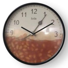 a clock showing the time in which you can see red and white stuff on it