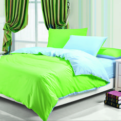 a bed with green and blue sheets in a room next to a window, books on the floor