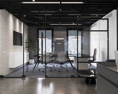 an office with glass walls and black chairs