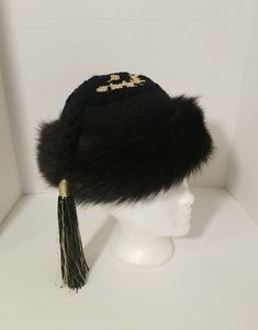 Vintage Yves Saint Laurent Black & Gold Hat with Tassle Made in France 1976 In very beautiful condition Comes with Appraisal Please see photos Luxury Adjustable Winter Hat, Handmade Black Mini Hats For Winter, Handmade High Crown Black Hat, Handmade Black High Crown Hat, Traditional Black Brimmed Hat, Black Wide Brim Crochet Hat For Winter, Handmade Black Mini Winter Hats, Traditional Black Beanie Hat, Ysl Fringe