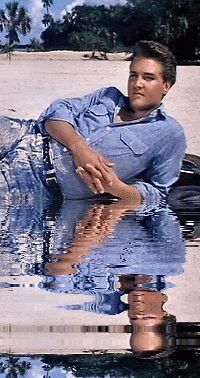 a man laying on the ground in water