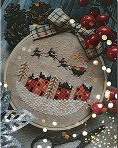 a cross stitch christmas scene with santa's sleigh