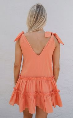 This sorbet colored mini dress is adorable and such a fun pop of color for your summer wardrobe. We love the v-neckline, tie straps and ruffle tiered skirt. It's the perfect mini dress to style casually with sandals or sneakers or dress up with heels. Katie is 5'5" and is wearing size extra small extra small measurements: 36" bust | 31" length + tie straps 100% cotton WE ONLY OFFER STORE CREDIT FOR RETURNS! Feel free to email us at orders@shopriffraff.com or DM us with any questions regarding fi Western Tee, Gameday Outfit, Art Dress, Tier Skirt, Tiered Skirt, Summer Wardrobe, Jumpsuit Dress, Dresses For Sale, Dress Shop