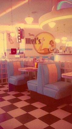 the interior of a diner with checkered flooring and blue booth booths, tables and chairs